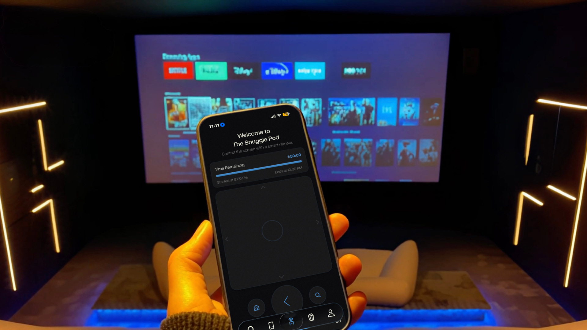 A hand holding a phone showing the neuk smart remote in front of a screening room screen