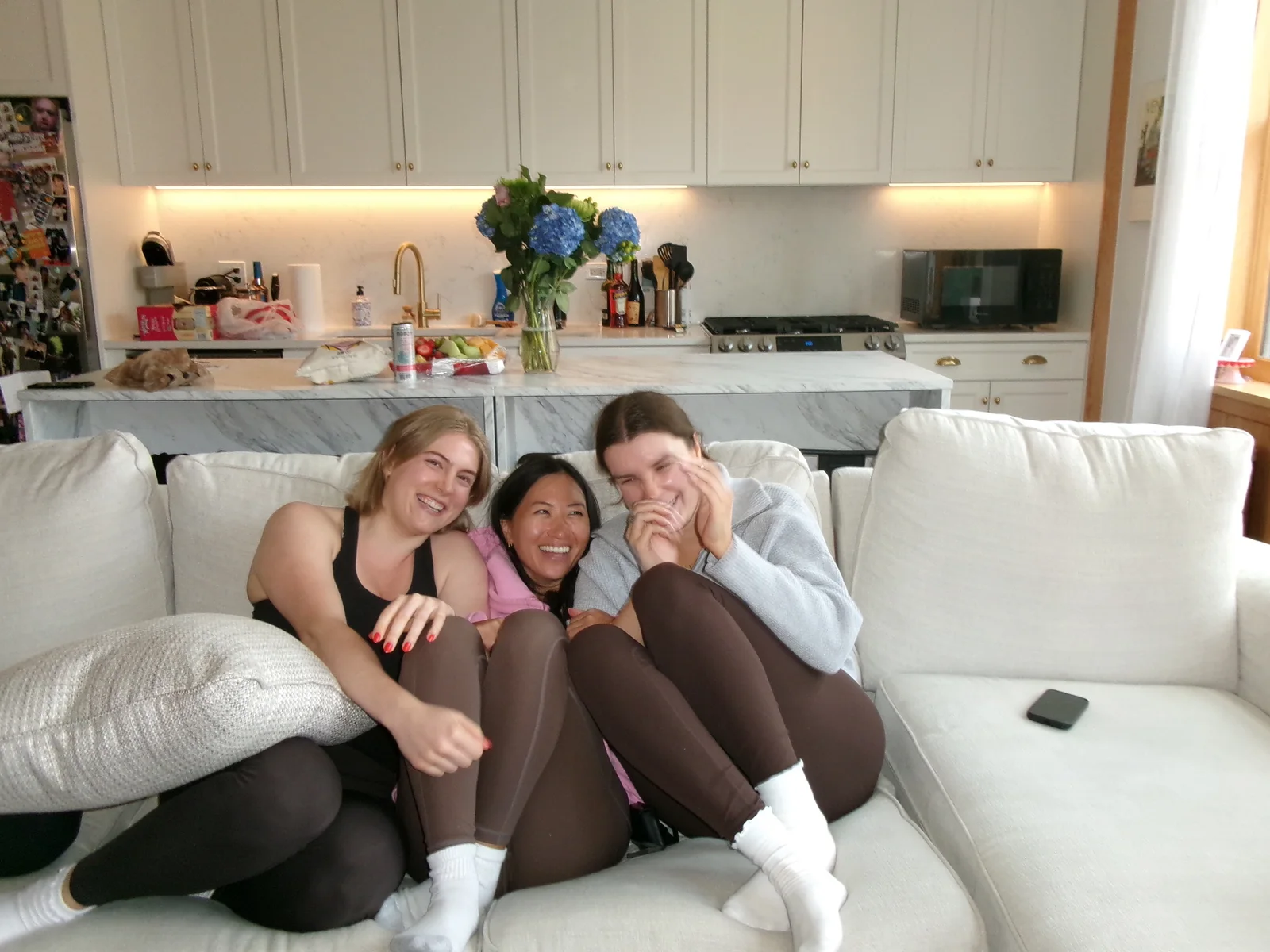 After: three friends laughing together on a couch