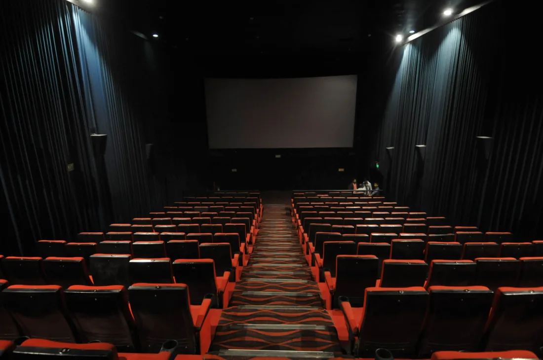 Rows of seats facing a movie theater screen