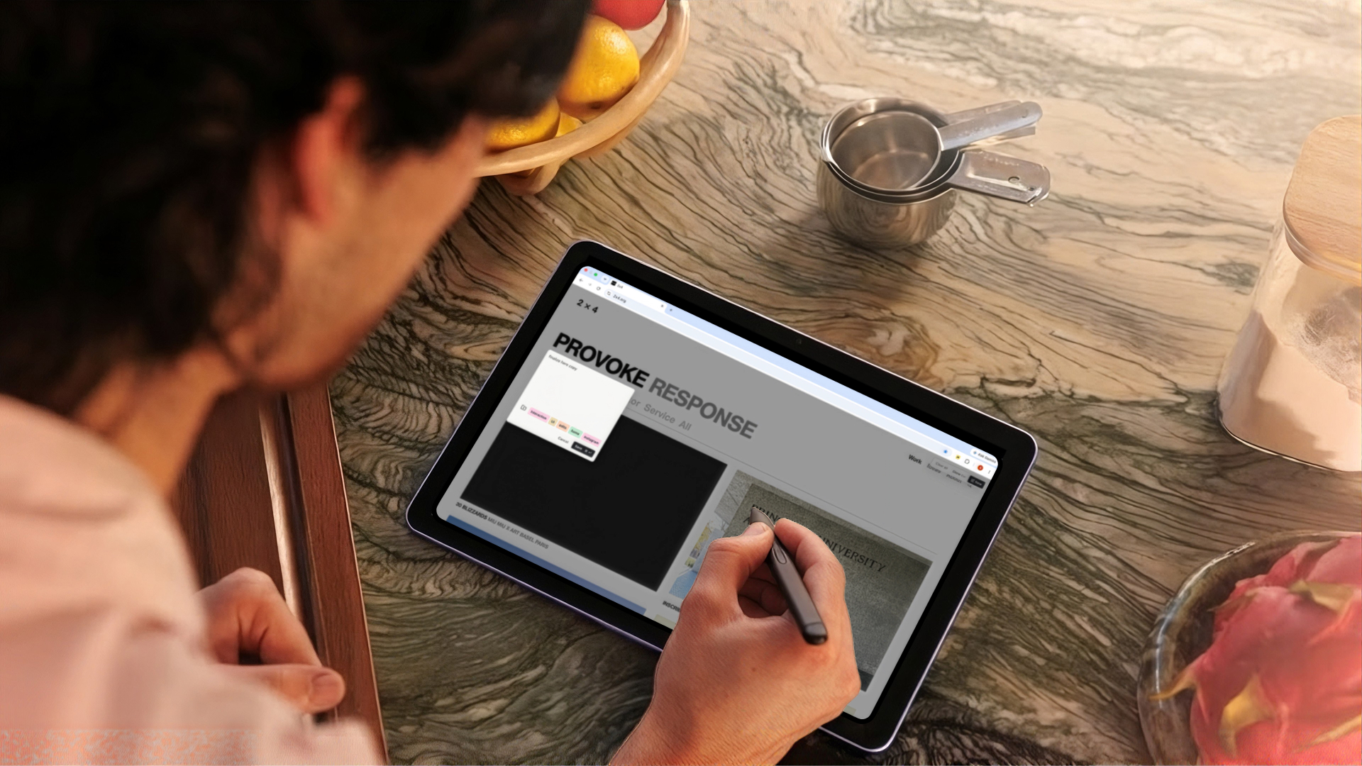Someone at a kitchen counter writing a Notate note on a webpage with a stylus on a tablet